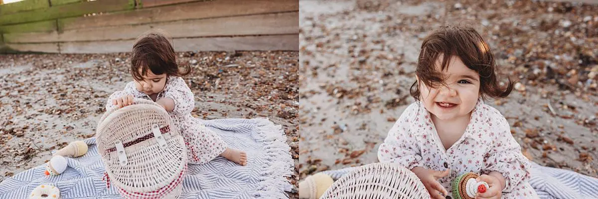 Family enjoying a sunset beach photo shoot on Hayling Island with their two dogs and one-year-old daughter