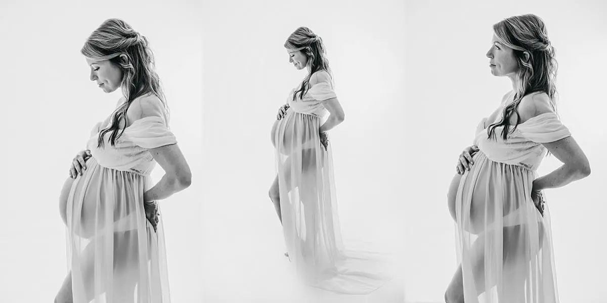 black and white image of pregnant lady in white maternity dress, classic timeless look