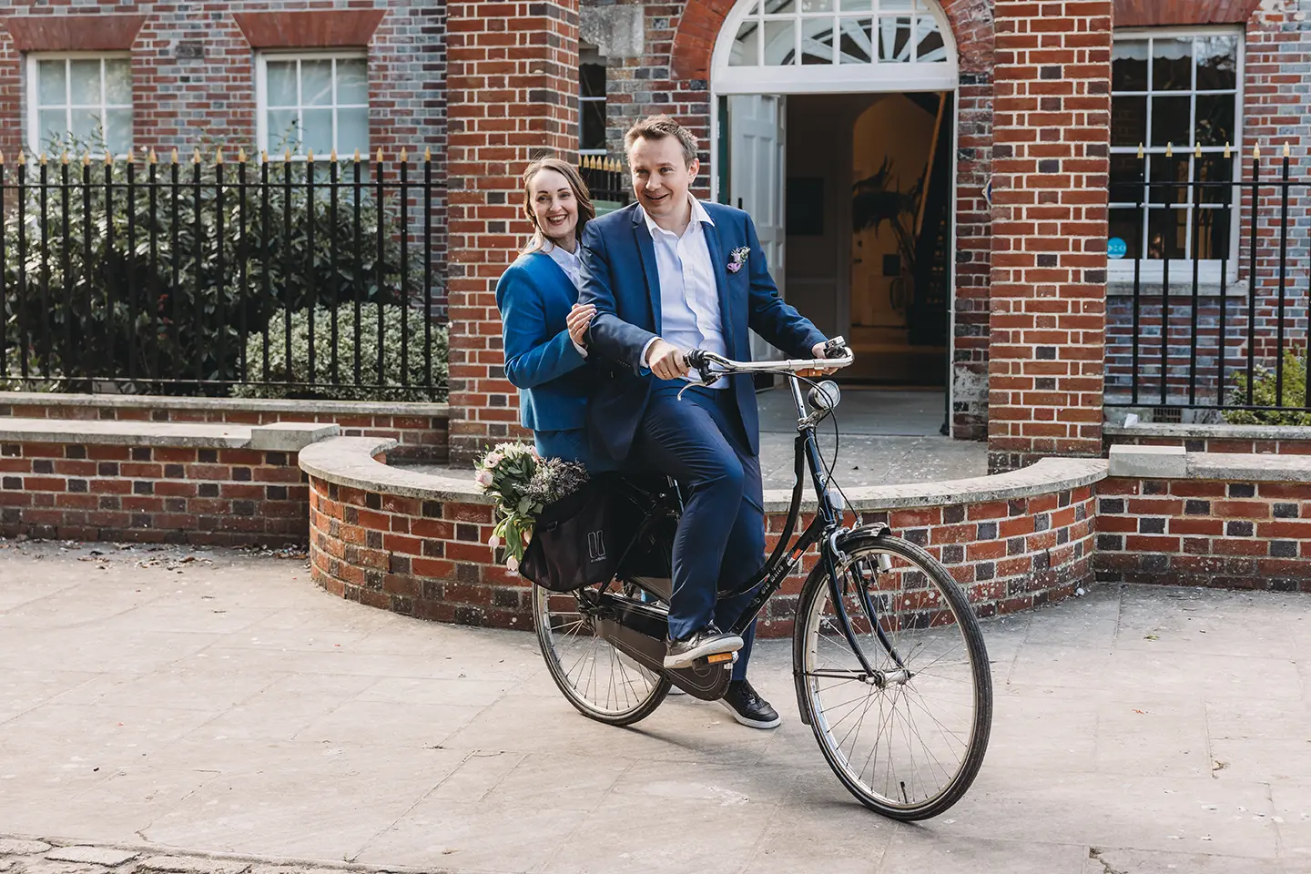 Portsmouth register office wedding photography couple on bicycle bride in blue linen suit