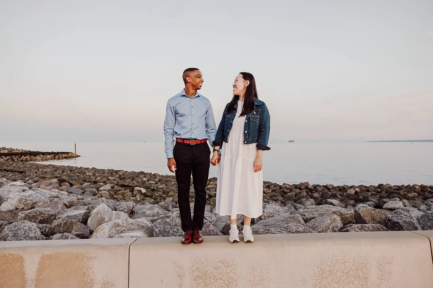 Walking hand in hand along Southsea promenade after proposal