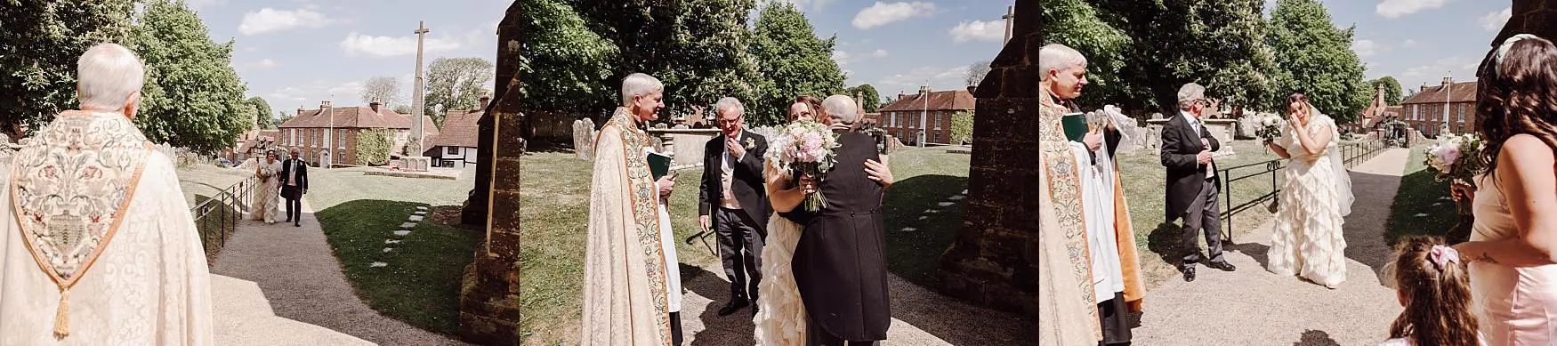 Wedding guests congratulating the bride outside the church in Harting near Petersfield, photographed on a bright spring wedding day by a Chichester wedding photographer.