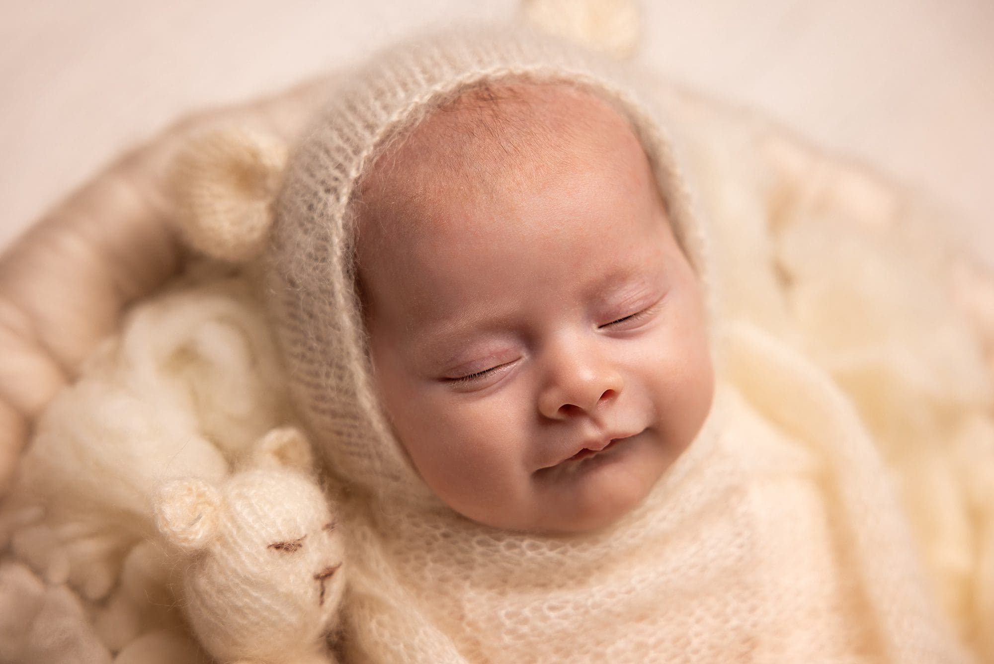 cute newborn baby smiling during professional baby newborn photoshoot in Portsmouth Hampshire