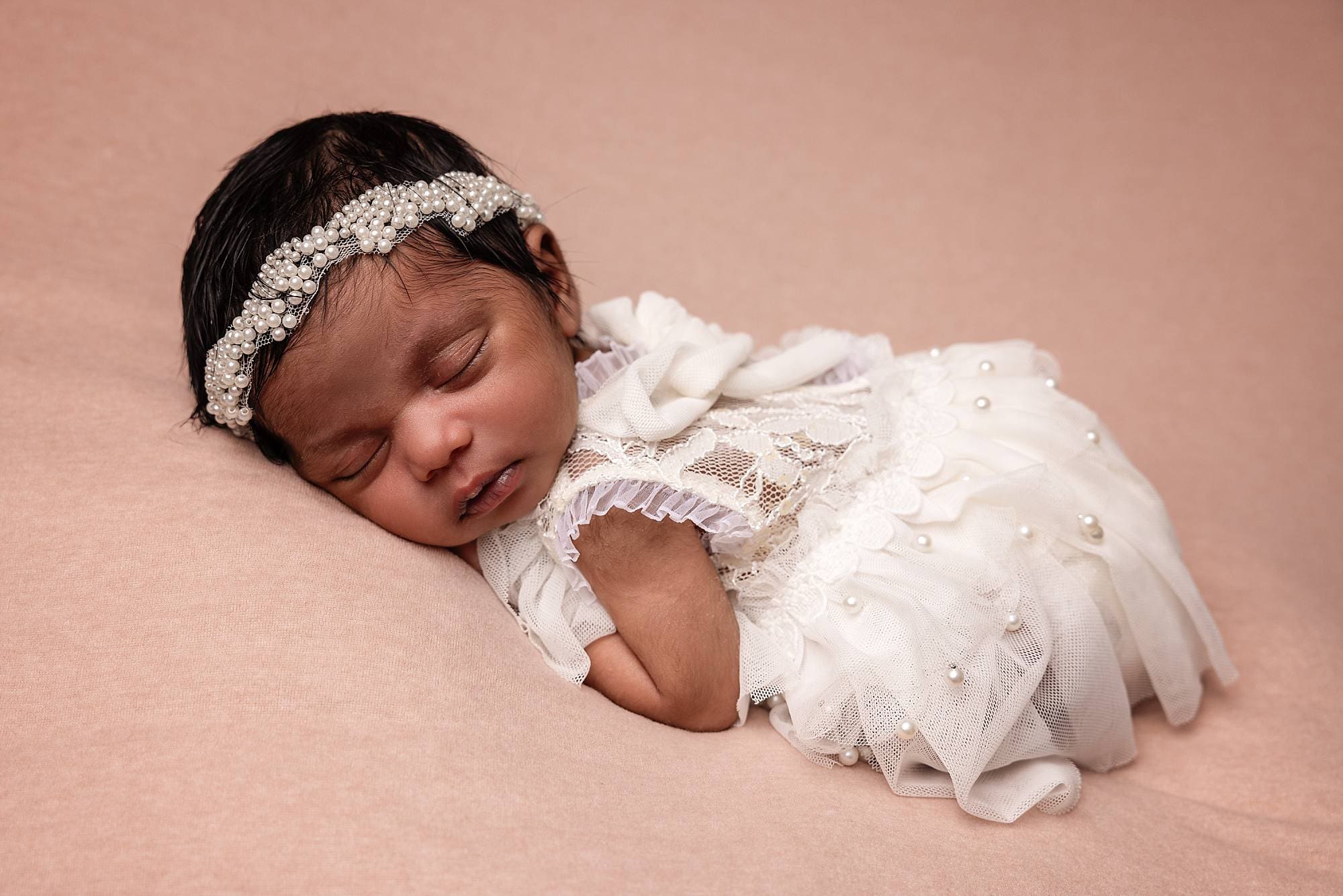Newborn baby in a peaceful pose captured by photographer in Emsworth, Hampshire