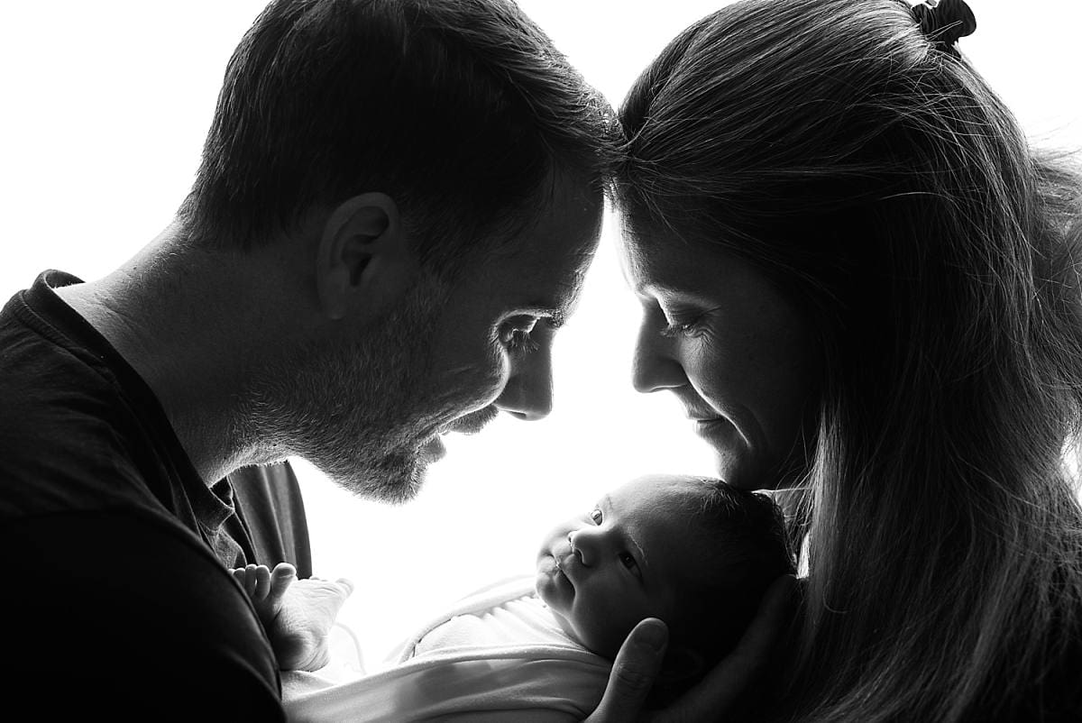 mum and dad sillouette portrait with baby, black and white, Ania Photo, Newborn photographer Chichester West Sussex photo session