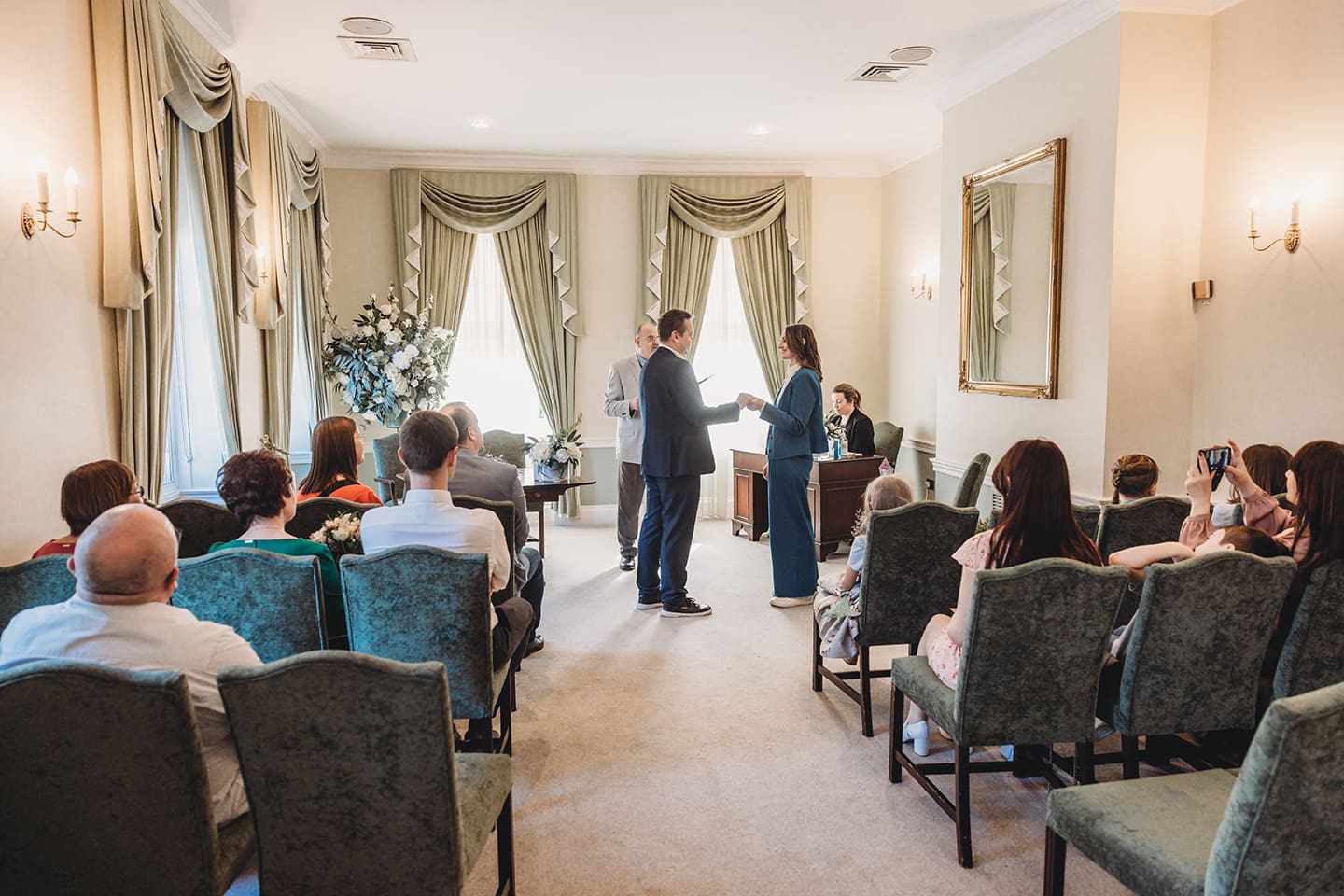 Portsmouth register office wedding photography couple on bicycle bride in blue linen suit