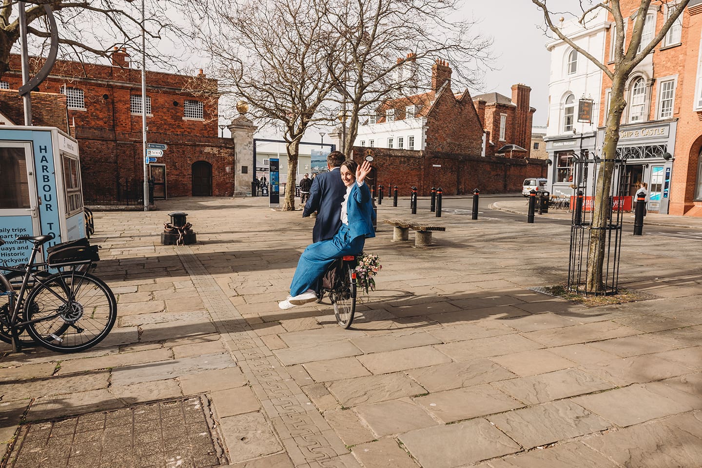 Portsmouth register office wedding photography couple on bicycle bride in blue linen suit