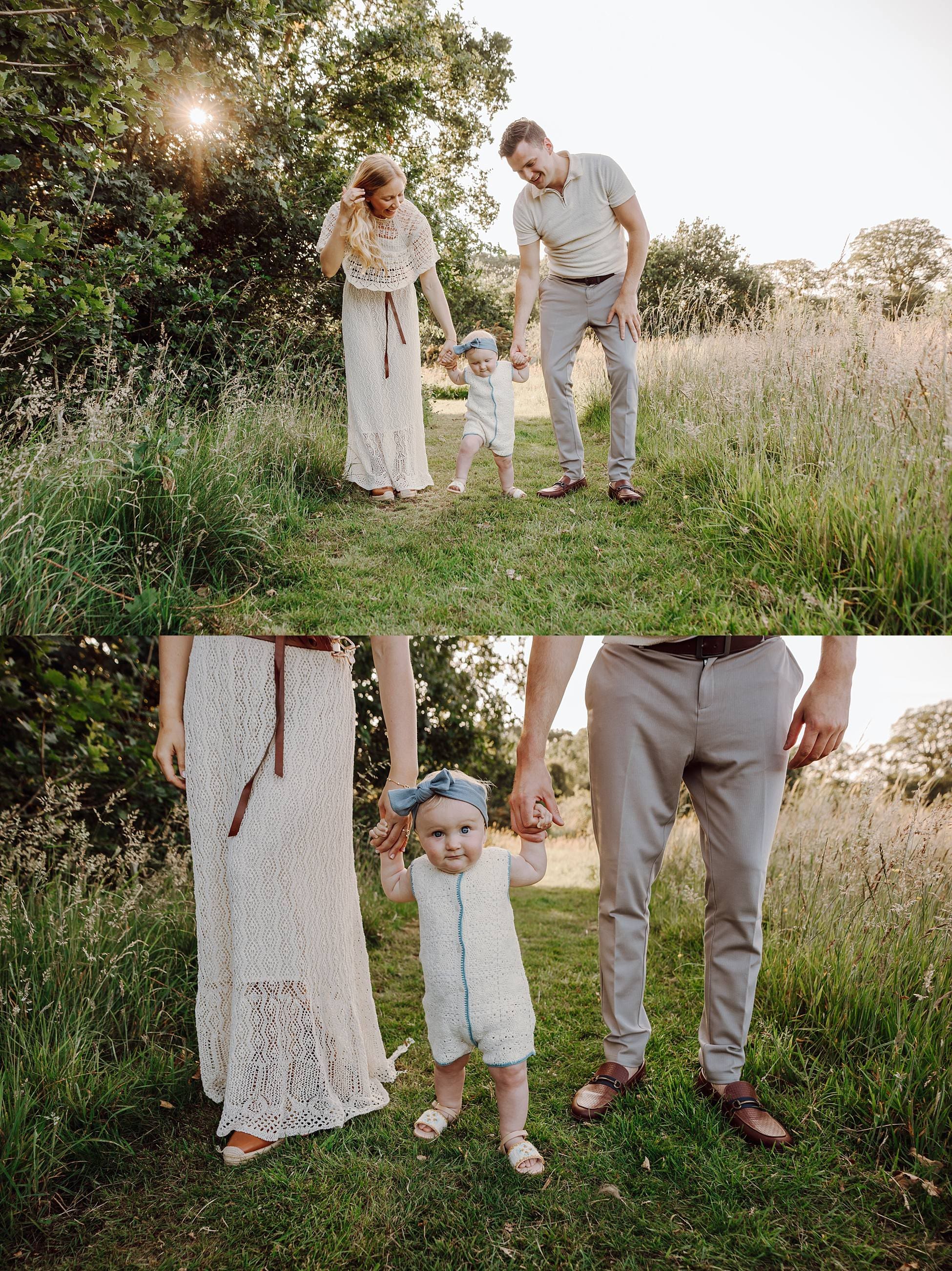 Family walking hand in hand through meadow in Denmead