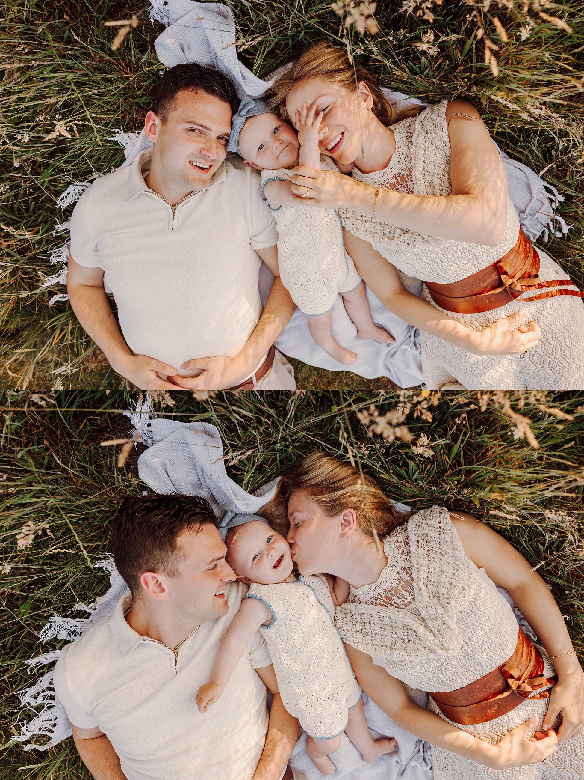 Parents lying in grass with toddler during summer session