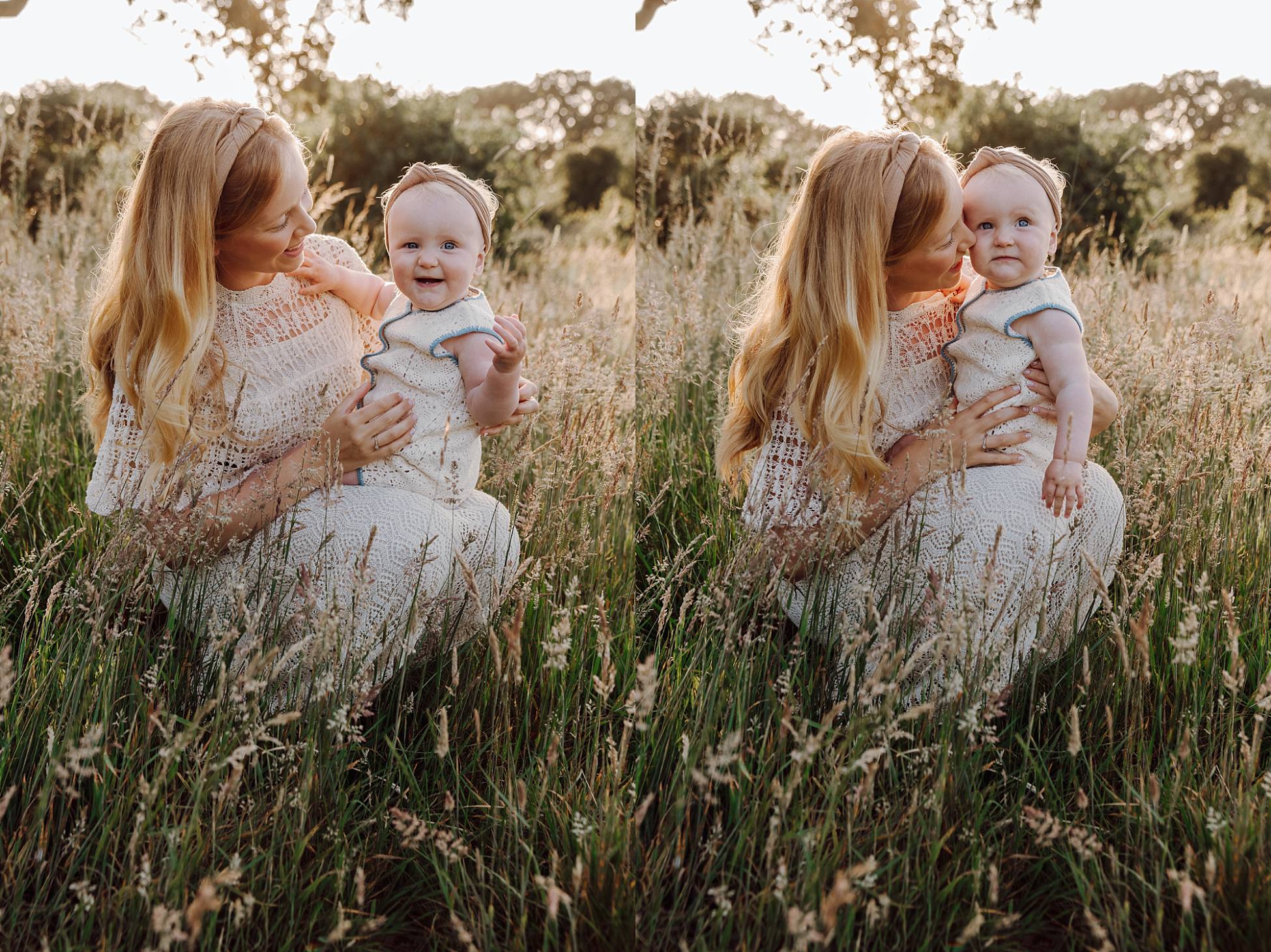 Mum cuddling baby girl in long grass at golden hour