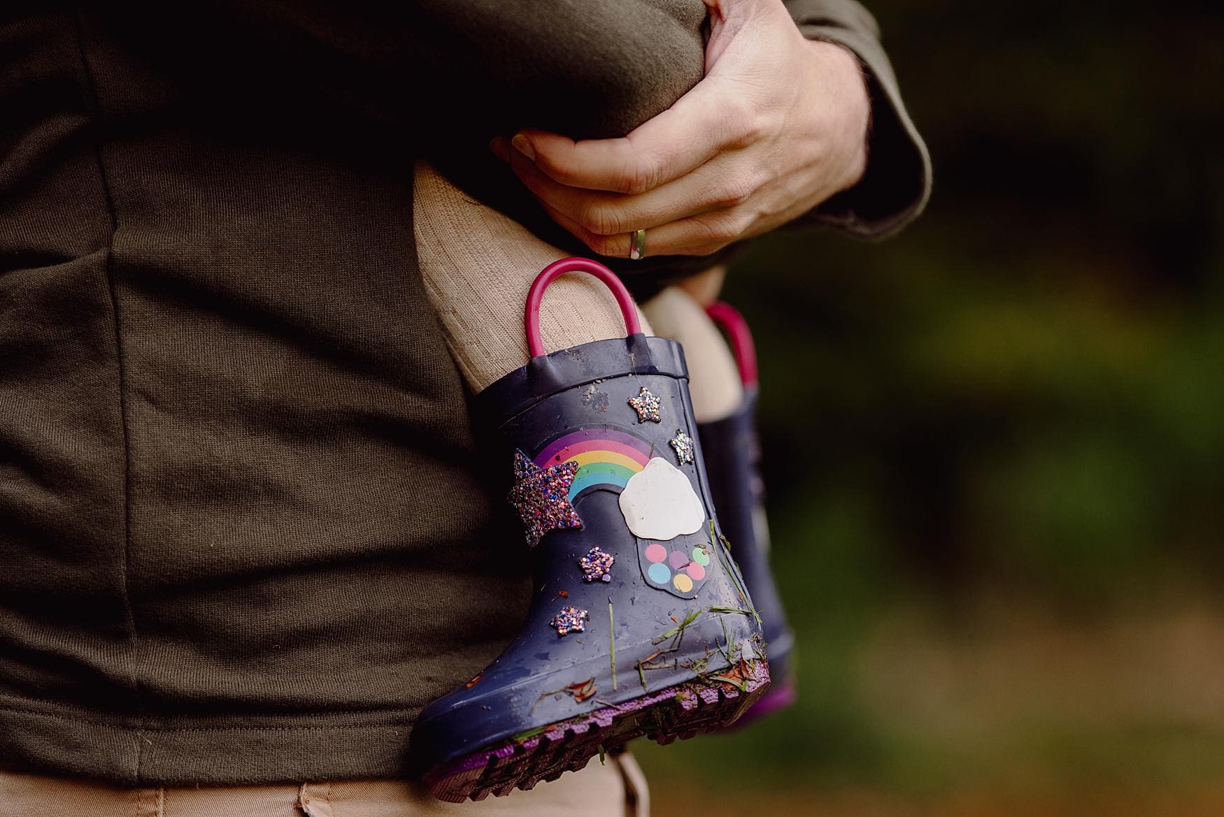 Close-up of child’s rainbow wellies during autumn family session in Hampshire countryside