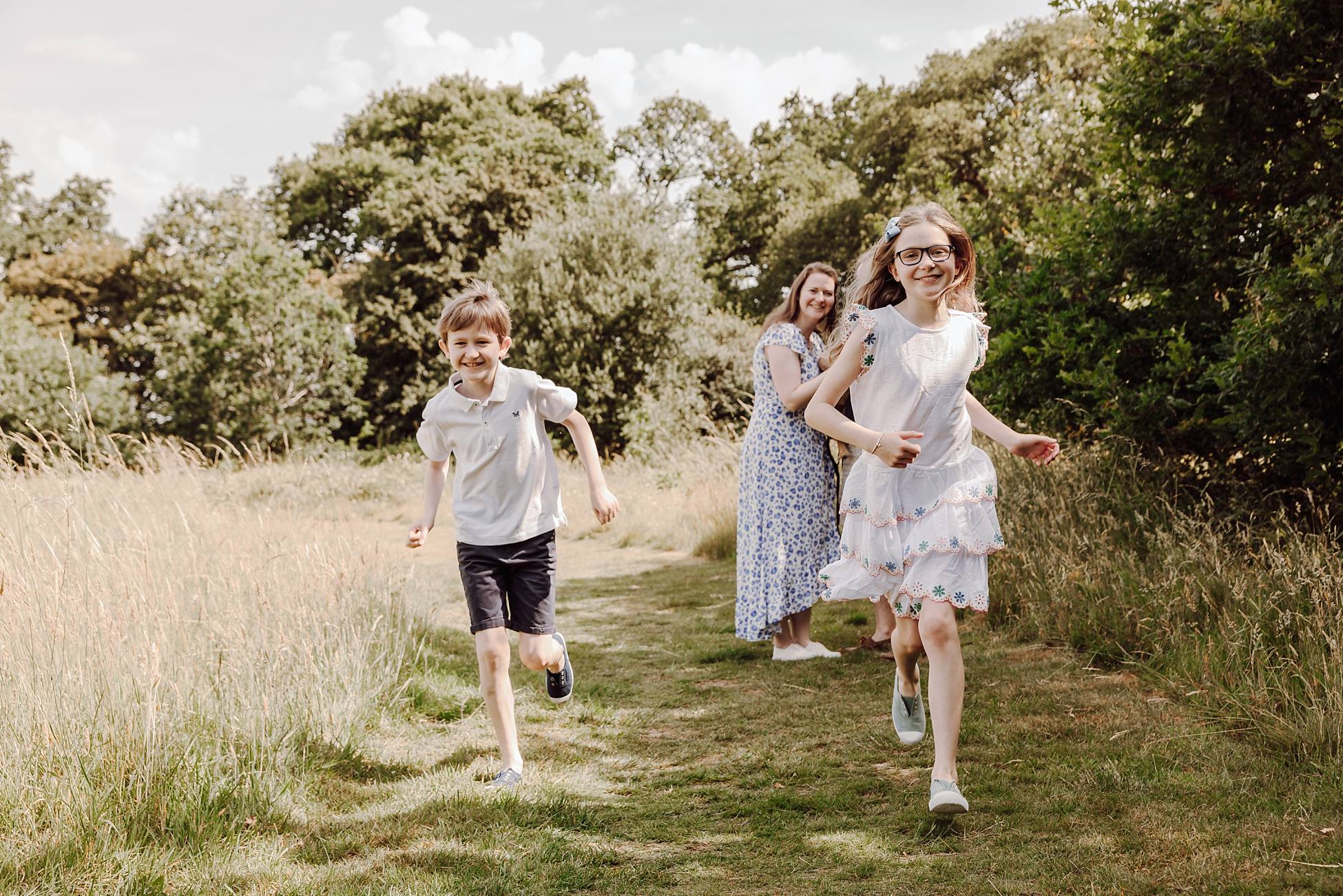 Children running and playing during natural outdoor family photography session