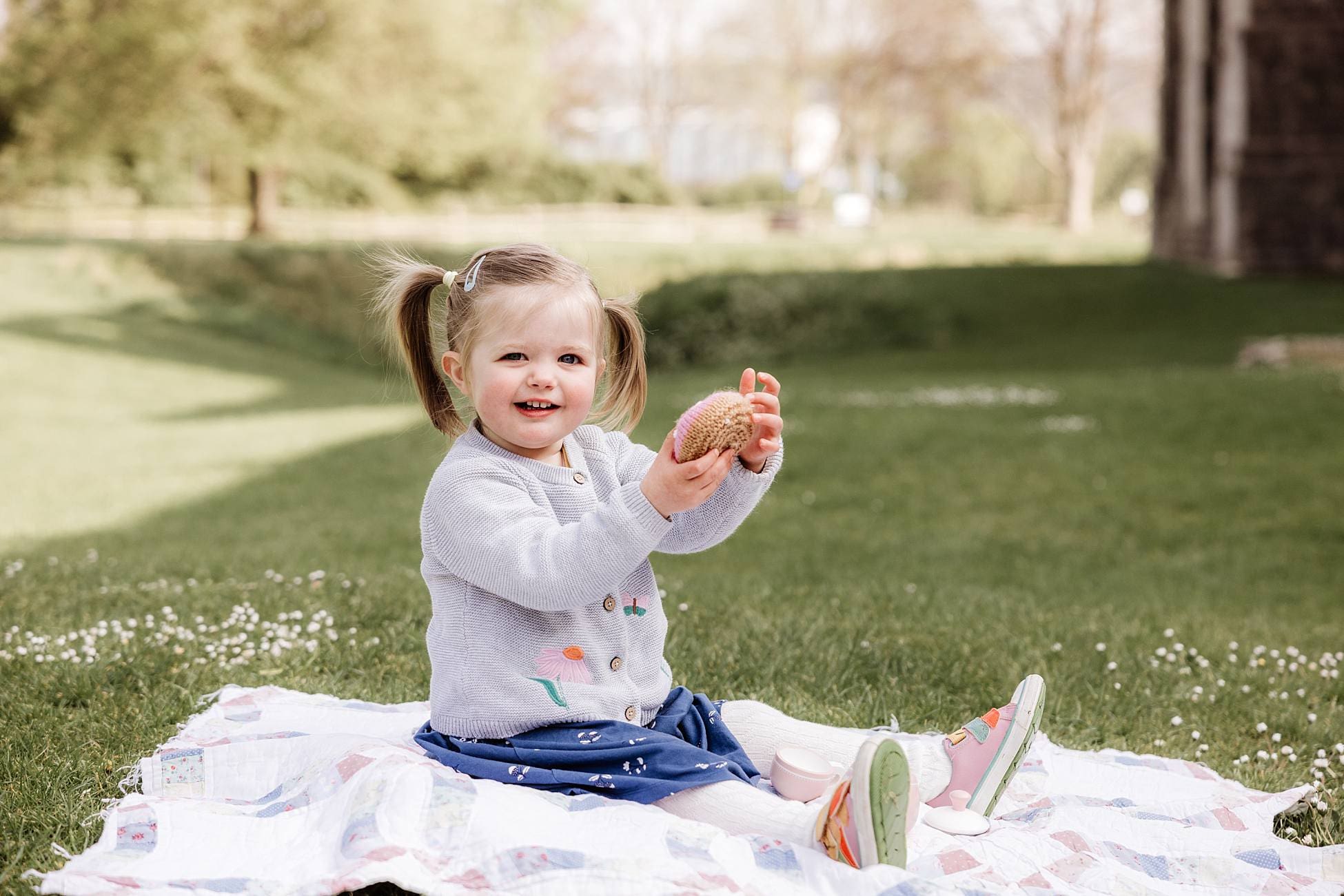 Parents and toddler enjoying relaxed outdoor family photoshoot