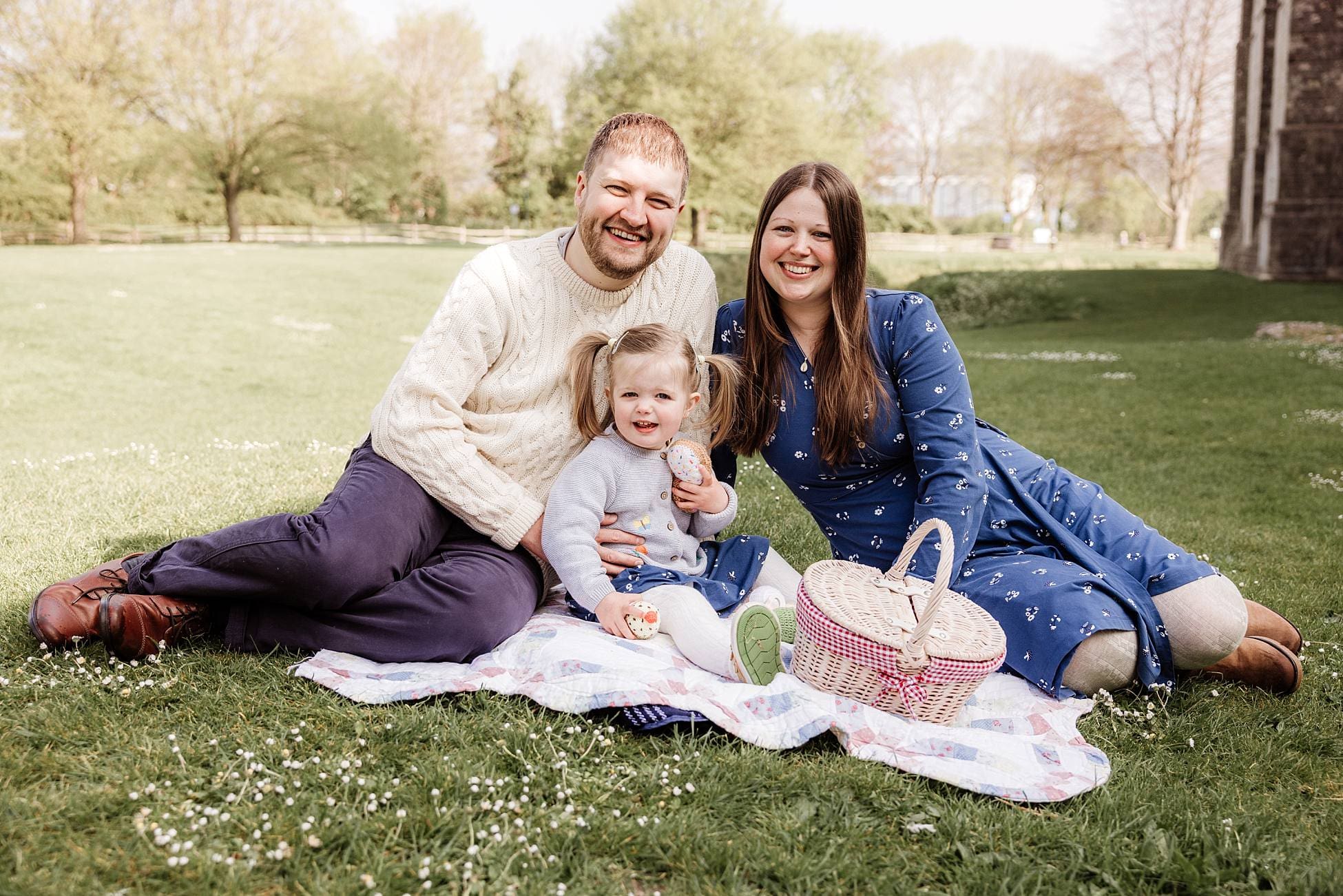 Parents and toddler enjoying relaxed outdoor family photoshoot