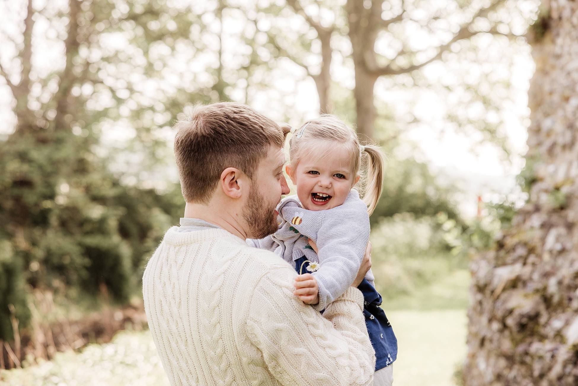 Parents and toddler enjoying relaxed outdoor family photoshoot