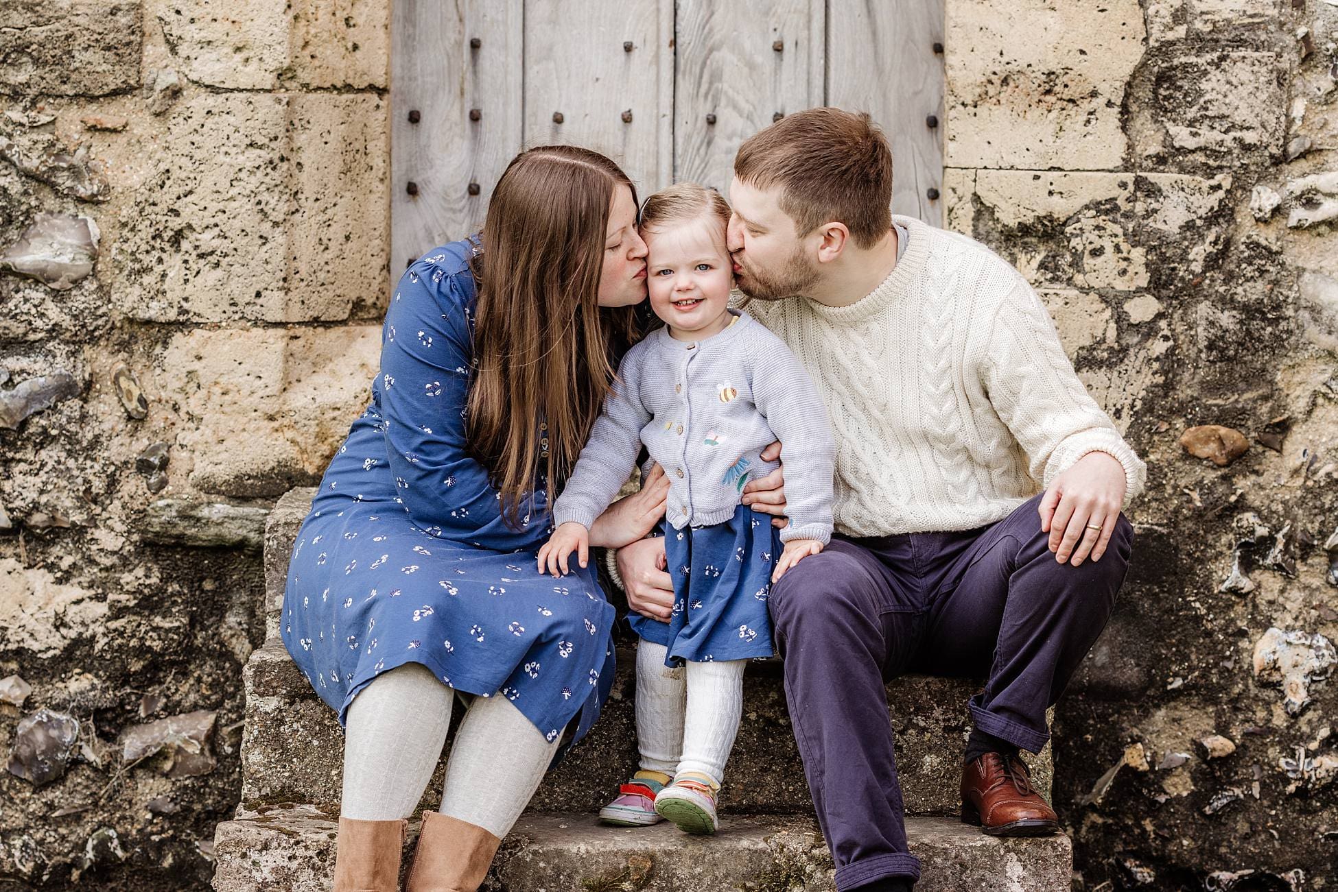 Parents and toddler enjoying relaxed outdoor family photoshoot