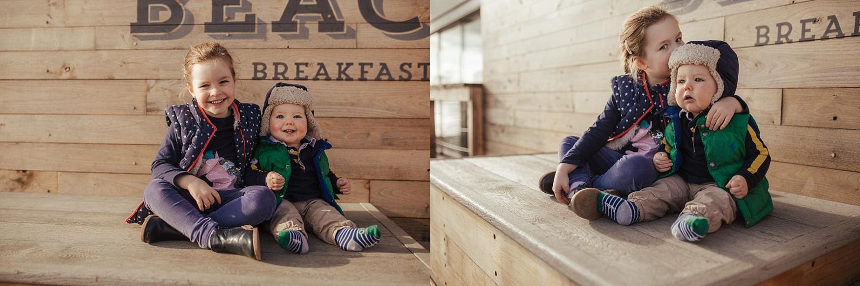 Two young siblings sitting on a wooden bench outside Southsea Beach Café during a family photoshoot, captured by Southsea family photographer