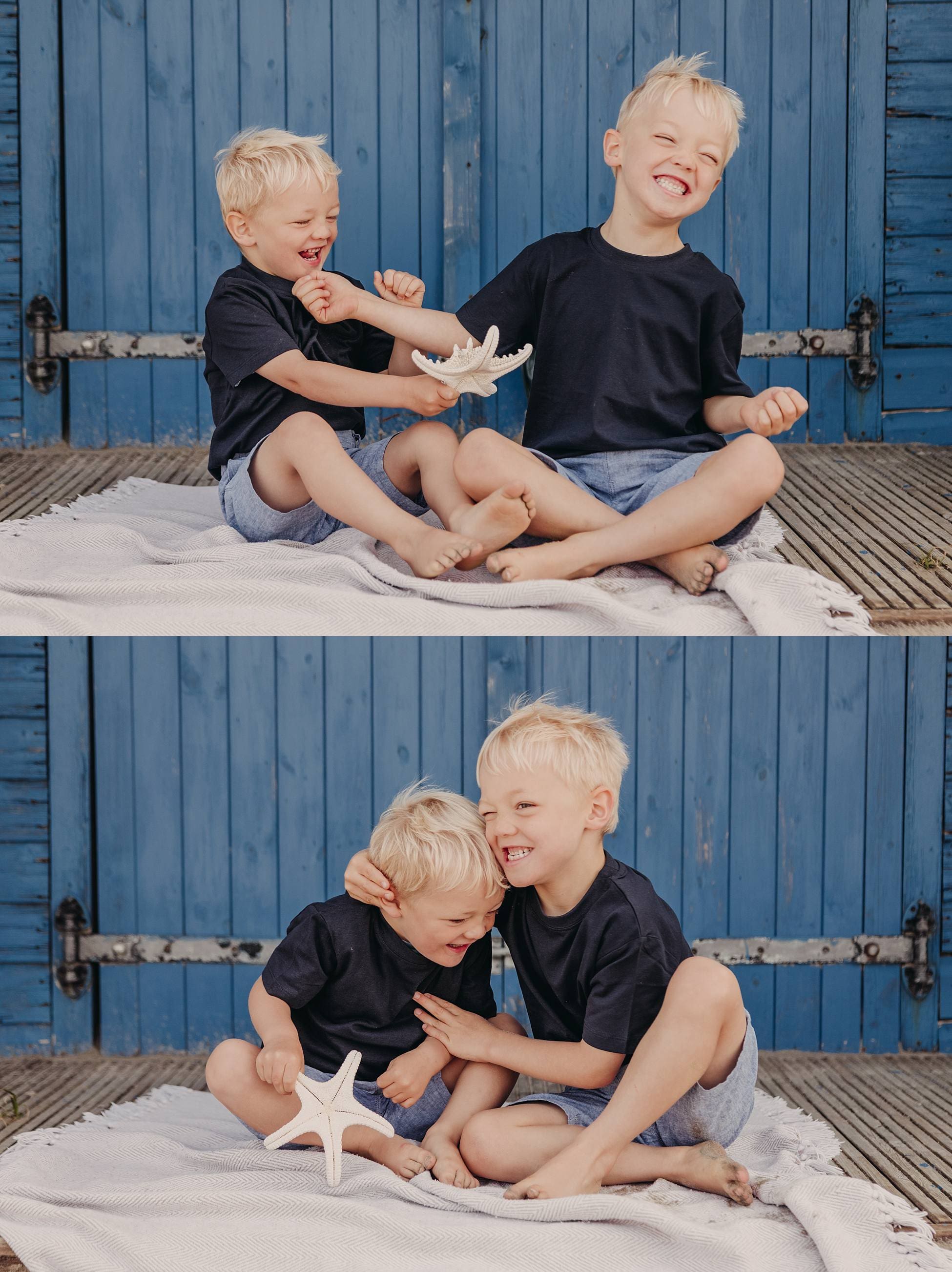Brothers sitting on beach steps, smiling and playing together with natural light