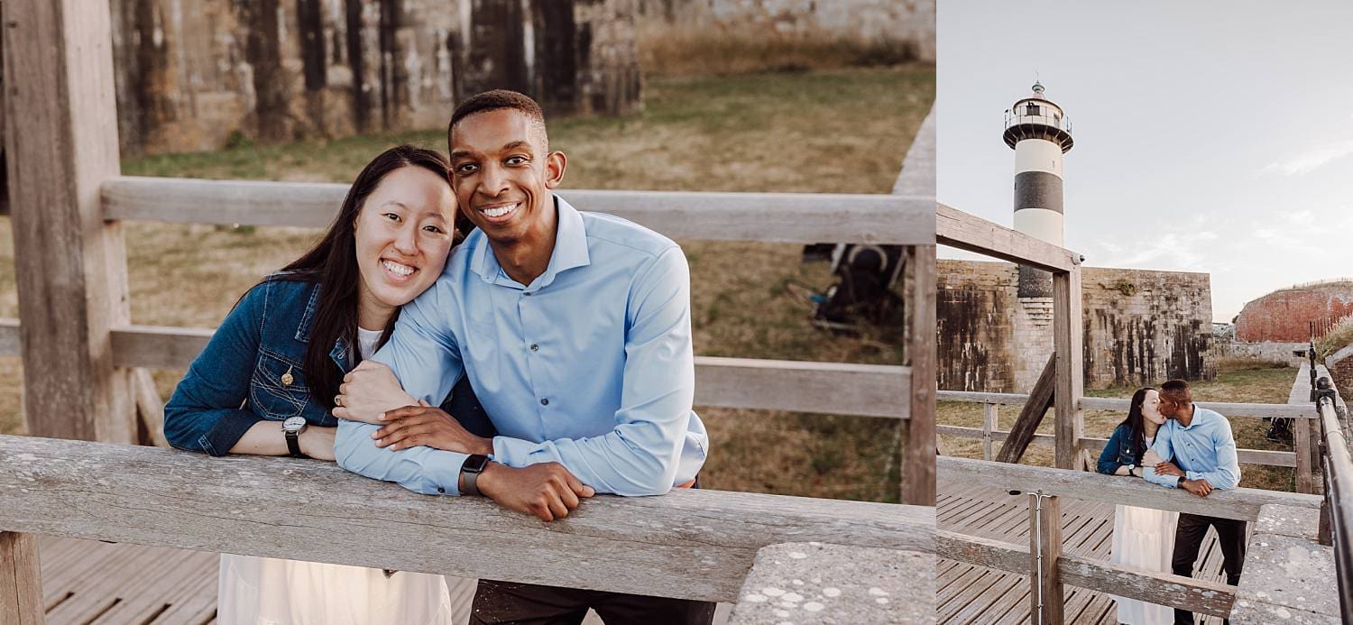 Engaged couple laughing at historic lighthouse in Portsmouth