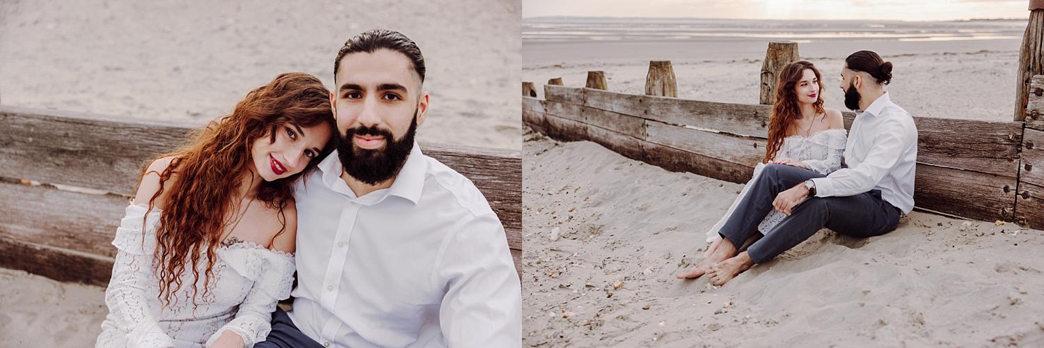 Romantic golden hour portrait of couple embracing on sandy beach at West Wittering engagement session.