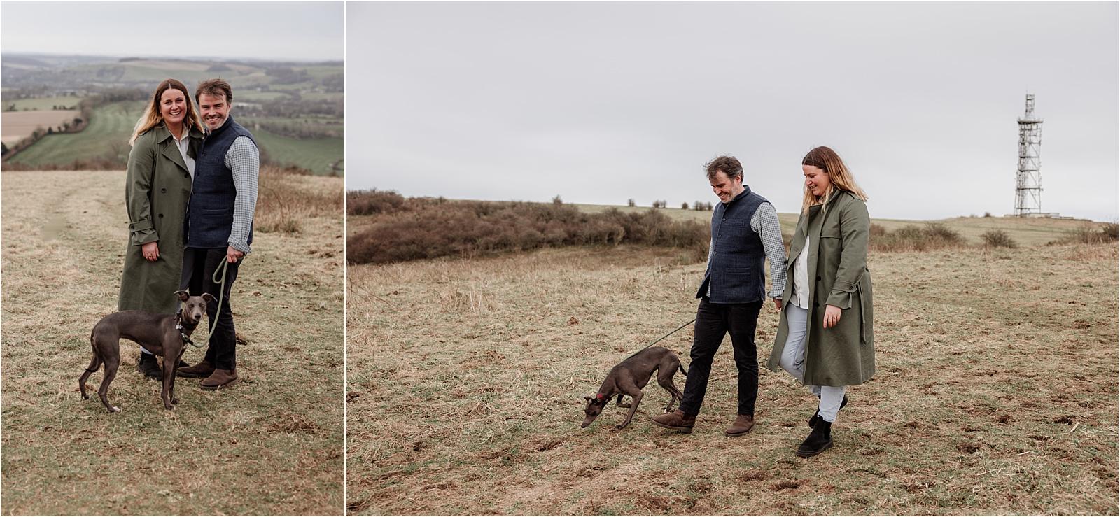 Couple walking their whippet along the ridgeline during an engagement photoshoot in Hampshire