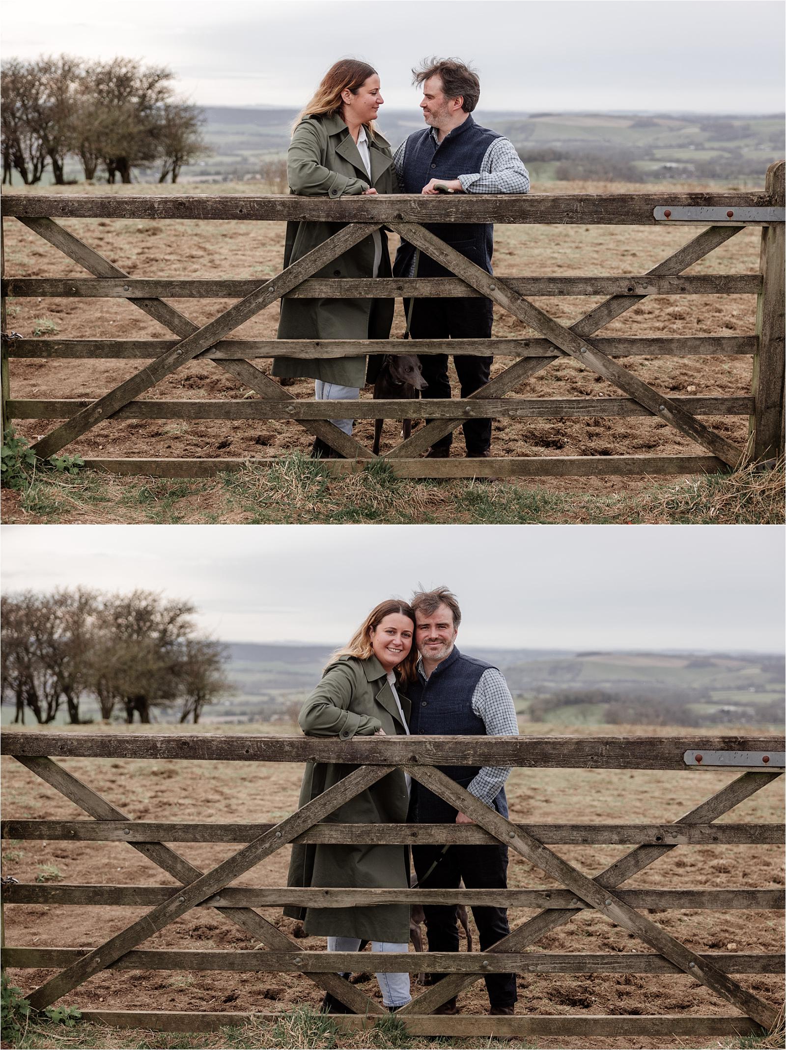 Couple photographed through a rustic wooden gate during their engagement photoshoot in Hampshire