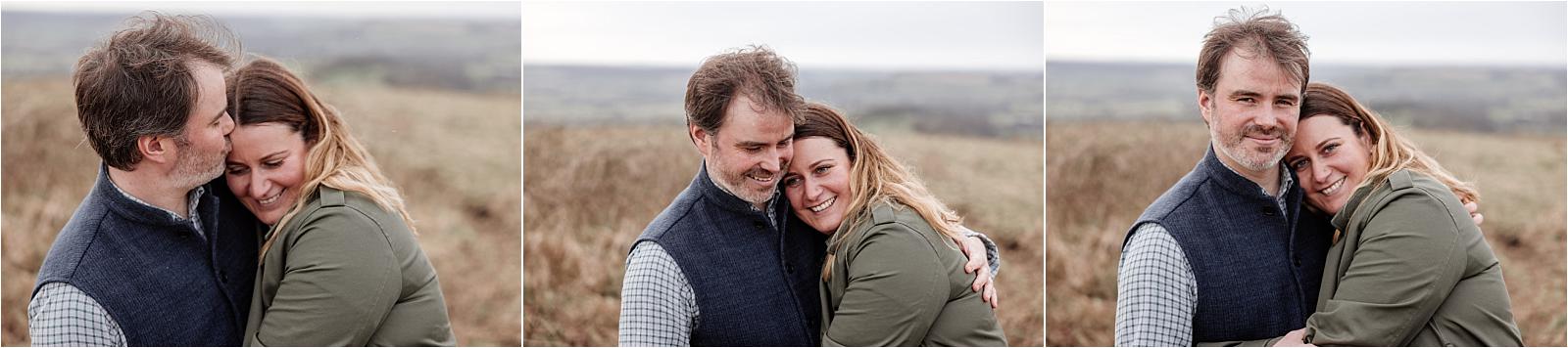 Couple cuddling in long golden grass during their autumn engagement photoshoot in Hampshire