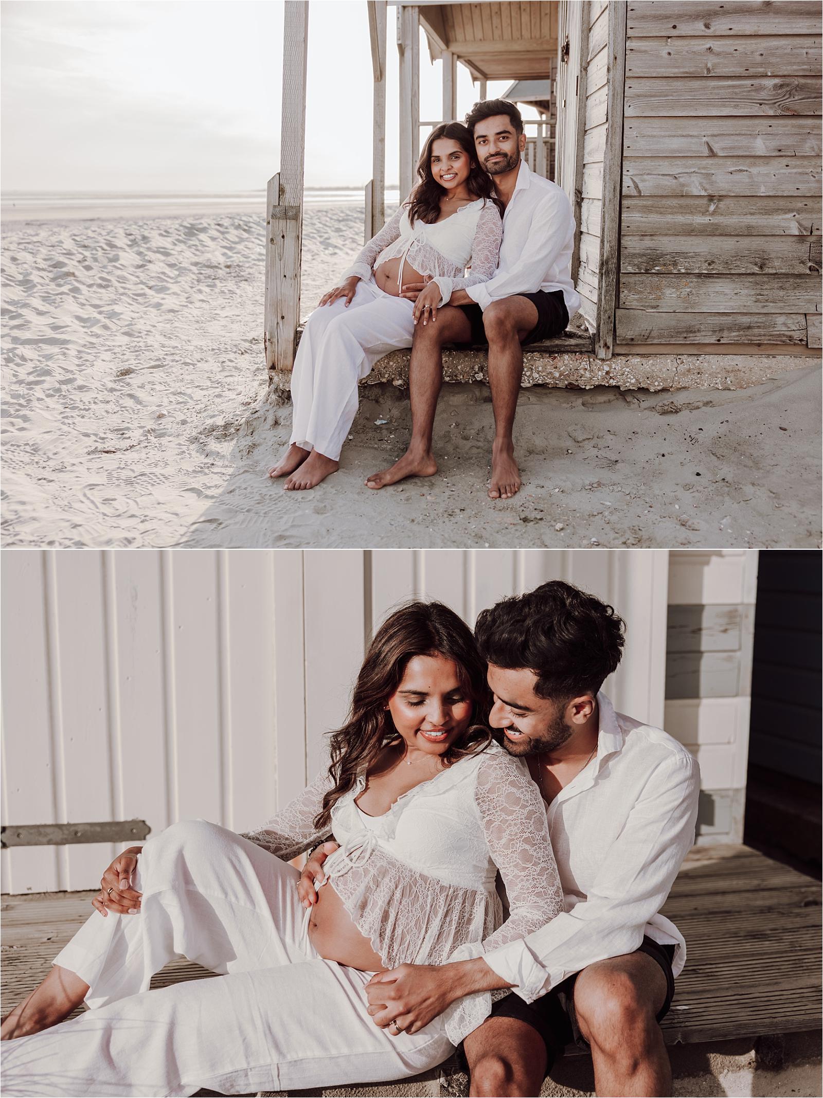 Couple relaxing against the groynes during a maternity session in West Sussex