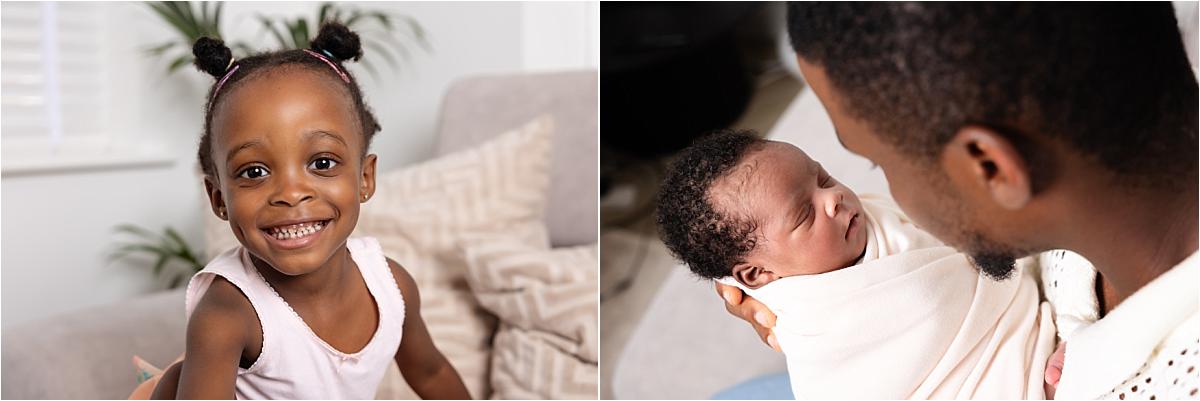 Older sister smiling at home and dad holding his sleeping newborn son